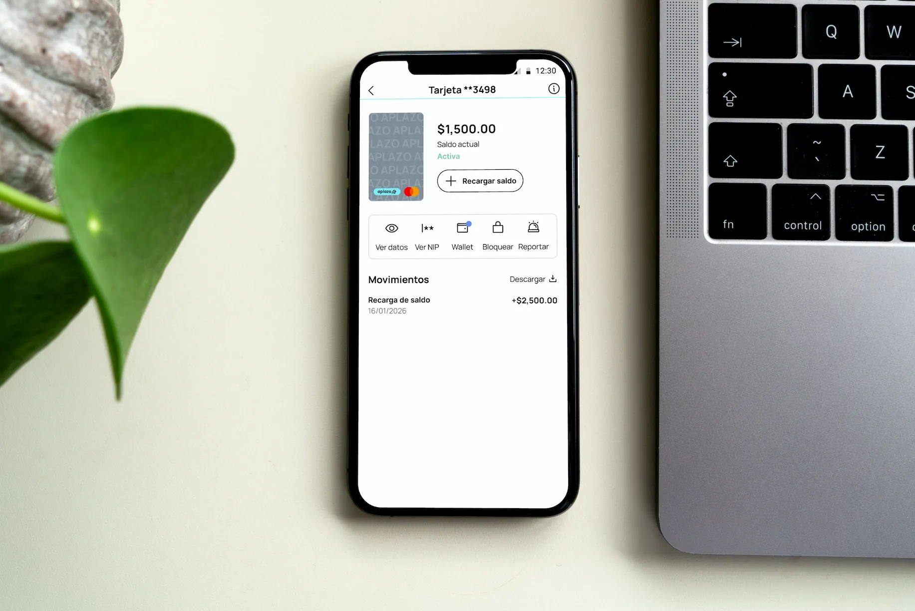 Aplazo card balance screen next to a laptop